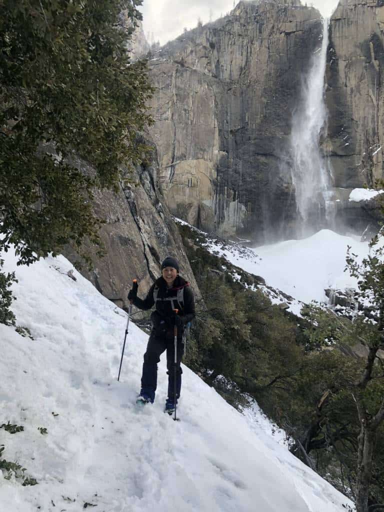 Theresa on snow with Yosemite Falls behind